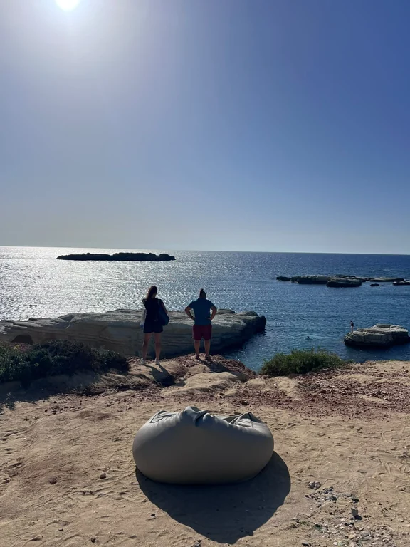 View from the cliff at Olive Tree Beach over rocks and islets off the coast of Peyia