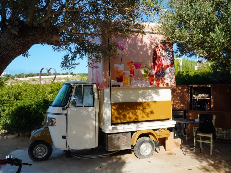 Converted Ape three-wheeler used as a drinks van at Olive Tree Beach